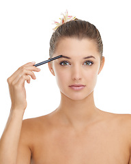 Image showing Makeup, portrait and woman with eyebrow pencil in studio for drawing, filler or shadow on white background. Beauty, tools and face of female model with brow shade pen for microblading, shape or tint