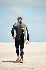 Image showing Surfer, back of man with surfboard and beach for extreme sports, wet suit and adventure in the sun. Summer vacation with travel and surfing in nature, ocean and exercise with hobby in Australia