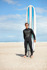 Image showing Beach, portrait and happy man with surfboard in summer for exercise, fitness for body health or outdoor mockup. Surfer, wetsuit and smile of person by ocean for water sports, travel or holiday by sea