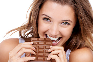 Image showing Woman, eating chocolate and portrait, candy and sweet tooth with pleasure and craving sugar on studio background. Hungry, snack and meal for comfort, dessert and sweets for calories, diet and bite