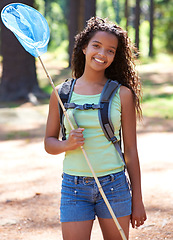 Image showing Girl, kid and butterfly net in forest for adventure and hiking outdoor, smile in portrait and backpacking. Travel, young explorer and happy in environment for trekking and explore nature for insects