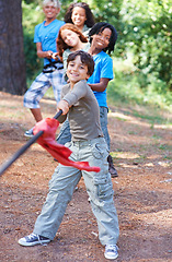 Image showing Children, forest and tug of war for play adventure, challenge and strength game in woods with summer camping. Kids, diversity or competitive in outdoor environment for fresh air or happiness by trees