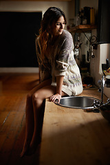 Image showing Woman, thinking and relax on kitchen table in home for morning break, sitting and daydreaming on weekend. Model, person and thoughtful with calm expression, ideas and contemplating in farmhouse