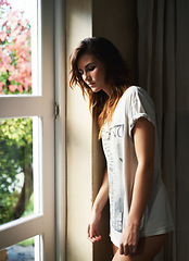 Image showing Thinking, depression and serious woman by window in home, lonely or mental health anxiety. Dream, stress and sad young person with worry for mistake, frustrated in crisis or remember memory of trauma