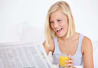 Image showing Happy woman, orange juice and reading newspaper on bed for headlines, energy and health body with wellness. Blonde hair, lady and thirsty for glass of fruit drink, morning and vitamin c with smile