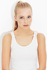 Image showing Portrait, workout and serious young woman in studio isolated on a white background. Face, healthy body and person exercise, blonde athlete training and sportswear for physical fitness in Switzerland