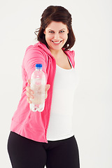 Image showing Happy woman, portrait and plus size with bottle of water in fitness for natural nutrition on a white studio background. Face of female person smile with mineral drink for sustainability or hydration