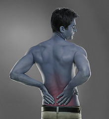 Image showing Model, back pain and spine problem in studio, medical crisis and muscle tension or injury of training. Man, joint ache or sport accident with red glow of inflammation or arthritis by grey background