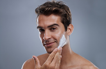 Image showing Portrait, shave cream and man with skincare, cosmetics and beauty on a grey studio background. Face, person and model with grooming routine and treatment with beard and moisture with wellness