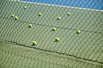 Image showing Sport, fitness or tennis balls on floor for training, exercise or competitive match to start in summer. Green, background or court for health or hobby with equipment on the ground ready for a game