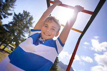 Image showing Child, monkey bars and park in portrait, smiling and energy at obstacle course on outdoor adventure. Happy male person, active and exercise on jungle gym, boy and fitness on playground in Australia