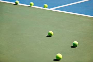 Image showing Sport, fitness or tennis balls on court for training, exercise or competitive match to start in summer. Green, background or floor for health or hobby with equipment on the ground ready for a game