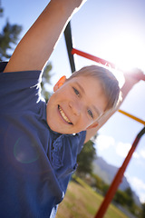 Image showing Child, monkey bars and smile in portrait, hanging game and obstacle course on outdoor adventure at park. Male person, active and exercise on jungle gym, boy and fitness on playground in Australia