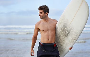 Image showing Happy man, surfboard and beach for fitness, waves or exercise in outdoor hobby, surfing or practice. Active young male person or surfer smile with board for training, seaside or ocean coast in nature