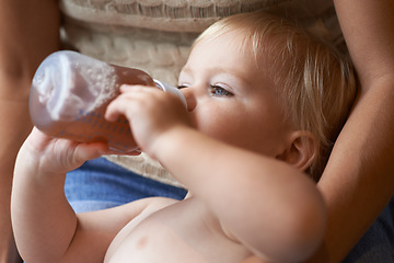Image showing Relax, bonding and baby drinking bottle and laying with mother for nap time with refreshing tea. Cute, sweet and infant, kid or toddler enjoying a beverage for nutrition, health and child development