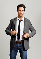 Image showing Fashion, serious and portrait of man in a studio with formal, elegant and classy outfit with blazer. Confident, handsome and young model from Canada with attractive style isolated by gray background.