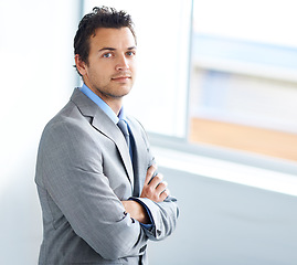 Image showing Portrait, serious and business man with arms crossed in workplace, corporate office or company pride. Face, professional employee and confident lawyer in suit, attorney or consultant working in Spain