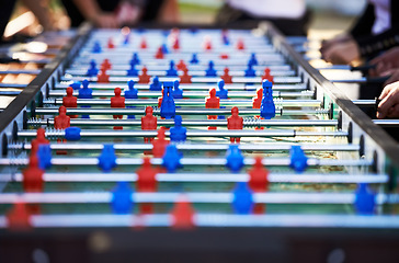 Image showing Foosball table, competitive and leisure with people playing a game outdoor at a music festival together. Party, event or social gathering with friends at a carnival for tabletop soccer or football