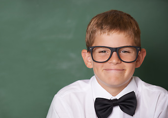 Image showing Happy boy child, portrait and chalkboard in classroom for learning, mockup space and education for future. Student kid, glasses and smile for studying, pride and school for knowledge with information