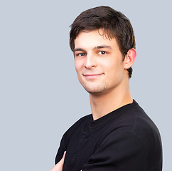 Image showing Portrait, smile and confident young man in studio on gray background with space for casual fashion. Face, happy and friendly with natural model on mockup in relaxed tshirt or clothes outfit for style