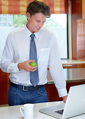 Image showing Happy man, coffee and apple by laptop in kitchen for morning, healthy breakfast or diet at home. Male person or freelancer with cup of tea or organic fruit by computer for business, meal or nutrition