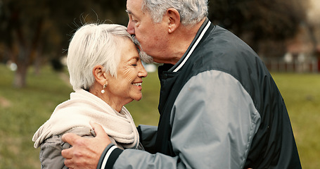 Image showing Love, smile and kiss with a senior couple hugging outdoor in a park together for a romantic date during retirement. Happy, support and an elderly man and woman bonding in a garden for romance