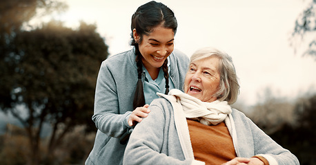 Image showing Senior woman, talking and outdoor with caregiver, nurse or healthcare service for person with a disability and wheelchair. Happy, face and elderly lady in park with care and support in retirement