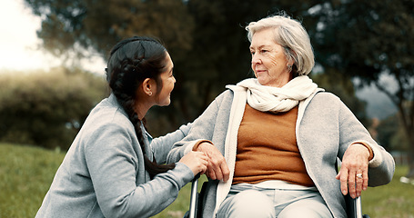 Image showing Caregiver helping woman with disability in park for support, trust and care in retirement. Nurse talking to happy senior patient in wheelchair for rehabilitation, therapy and conversation in garden