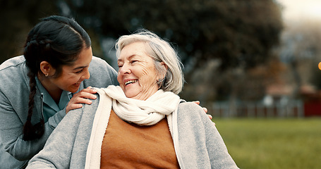 Image showing Caregiver helping woman with disability in park for support, trust and care in retirement. Nurse talking to happy senior patient in wheelchair for rehabilitation, therapy and conversation in garden