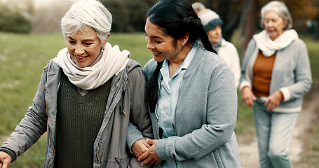 Image showing Happy, walking and a woman and caregiver in nature for talking, support and relax in the morning. Help, together and a young carer speaking to a senior patient in a park or garden for bonding