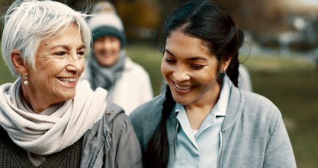 Image showing Caregiver, team and senior friends walking outdoor of a nursing home talking in a conversation for support and trust. Care, speaking and nurse exercise with elderly people for wellness and health