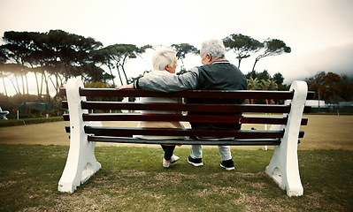 Image showing Hug, bench or old couple in park or nature talking or bonding together in retirement outdoors back view. Senior, elderly man or mature woman on date to relax with love, peace or care on calm holiday