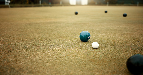 Image showing Green, balls and game of lawn bowling on grass, field or pitch in match or competition of outdoor bowls. Ball, moving and sport tournament at bowlers club, league or championship games on the ground
