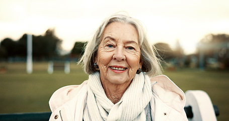 Image showing Face, senior woman and smile on park bench on vacation, holiday or travel in winter. Portrait, happy and elderly person in nature, garden or outdoor for wellness, freedom and relax in retirement