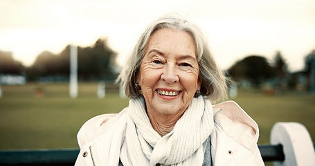 Image showing Face, senior woman and smile on park bench on vacation, holiday or travel in winter. Portrait, happy and elderly person in nature, garden or outdoor for wellness, freedom and relax in retirement