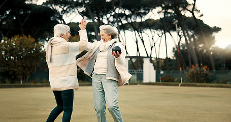 Image showing Senior women, high five and park for sport, lawn bowling and happy for fitness, goal and celebration in nature. Teamwork, elderly lady friends and metal ball for games, contest and winning together