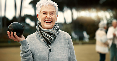 Image showing Senior woman, lawn bowling and park with face for sport, fitness or game for competition, health or fun. Elderly lady, metal ball and grass for contest, excited smile or workout in outdoor portrait