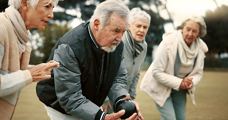 Image showing Senior man, game and senior people bowling in nature for retirement sports, teamwork and support. Bowling, friends and elderly man and woman in a group with a ball for a competition on a field togeth