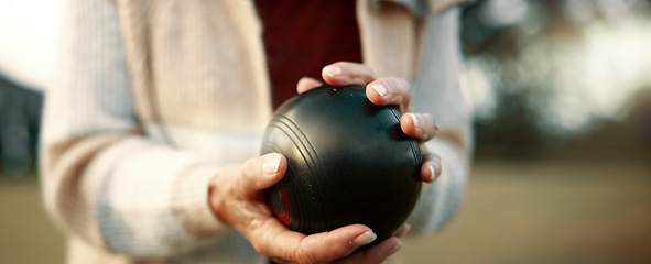 Image showing Senior woman, bowling and park on grass for sport, fitness and games for competition, health or fun. Elderly people, metal ball and lawn for contest, funny laugh or workout with blowing for good luck