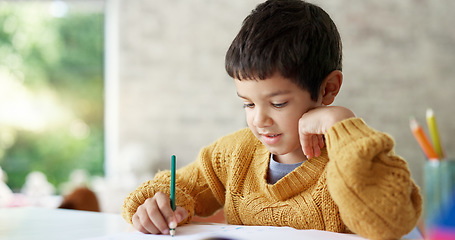 Image showing Child, drawing or boy writing homework on notebook in kindergarten education for growth development. Project, creative or young art student with color pencil learning or working on sketching skills