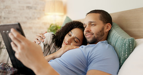 Image showing Couple, tablet and scroll in bed, morning and bond with internet video, movie and meme for love, care and hug. Man, woman and digital touchscreen for typing, social network app or web blog in house