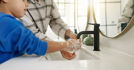 Image showing Woman, child and washing hands in bathroom, cleaning to prevent germs and dirt in home with soap, water and hygiene. Kid, mom and hand wash, teaching, learning and clean morning routine with family.