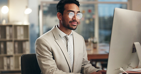 Image showing Office computer, night and happy man typing email, communication and networking with business consultant. Smile, reading and professional person contact social media user, network admin or employee