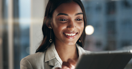 Image showing Office tablet, night and face of happy woman typing, scroll or check research, planning or customer experience analysis. Reading report, Indian person and media analyst working on online project