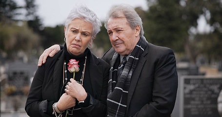 Image showing Funeral, graveyard and sad senior couple hug for comfort, empathy and support at memorial service. Depression, grief and man and woman embrace with flower for goodbye, mourning and burial for death