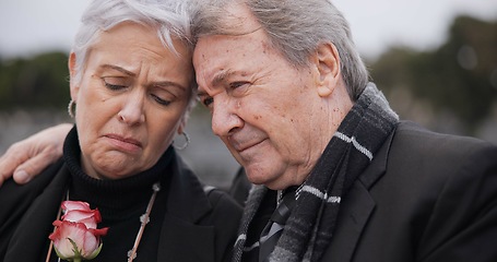 Image showing Funeral, graveyard and senior couple hug for comfort, empathy and support at memorial service. Depression, grief and sad man and woman embrace with flower for goodbye, mourning and burial for death