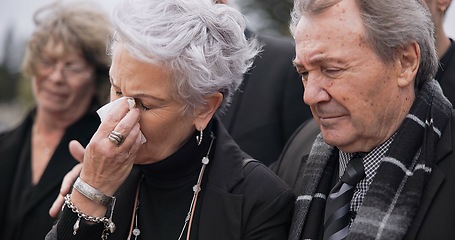Image showing Death, funeral and senior couple crying together in pain or grief for loss during a ceremony or memorial service. Tissue for tears, support or empathy with an elderly man and woman feeling compassion
