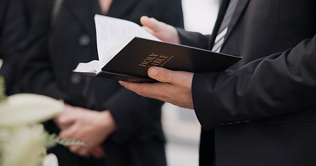 Image showing Bible, funeral and hands reading of a priest for religion, sad and mourning event in church. Faith, male person and spiritual passage with worship and book for grief with support and condolences