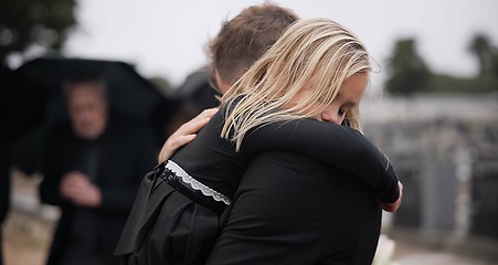 Image showing Sad, death and a girl with her father at a funeral for grief or mourning loss together outdoor. Family, empathy and a man holding his daughter at a memorial service or ceremony for condolences