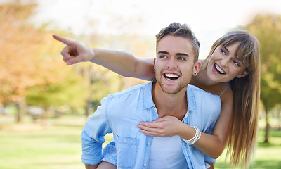Image showing Piggy back, pointing and couple in a park, love and romance with happiness and relationship. Man carrying woman, outdoor and marriage with joy and bonding together with nature and summer break